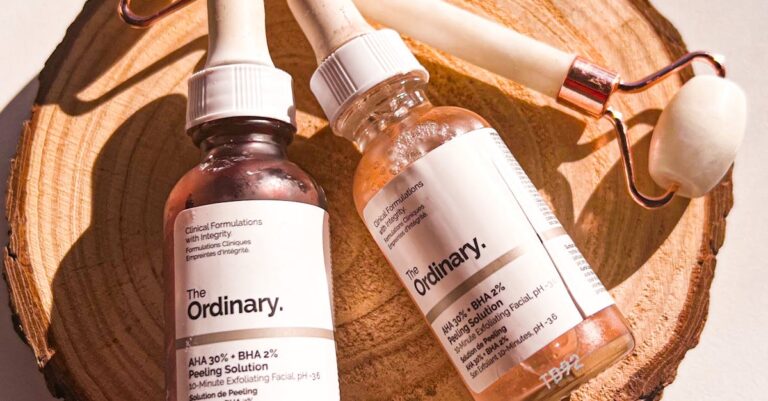 Flat lay of skincare products and facial roller on natural wooden slice for beauty and self-care.