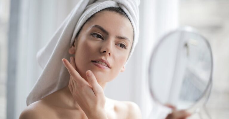 A serene and elegant woman enjoys a skincare ritual, enhancing her natural beauty in the comfort of her home.