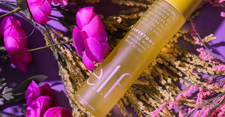 Vibrant skincare bottle with pink flowers and foliage, creating a fresh look.
