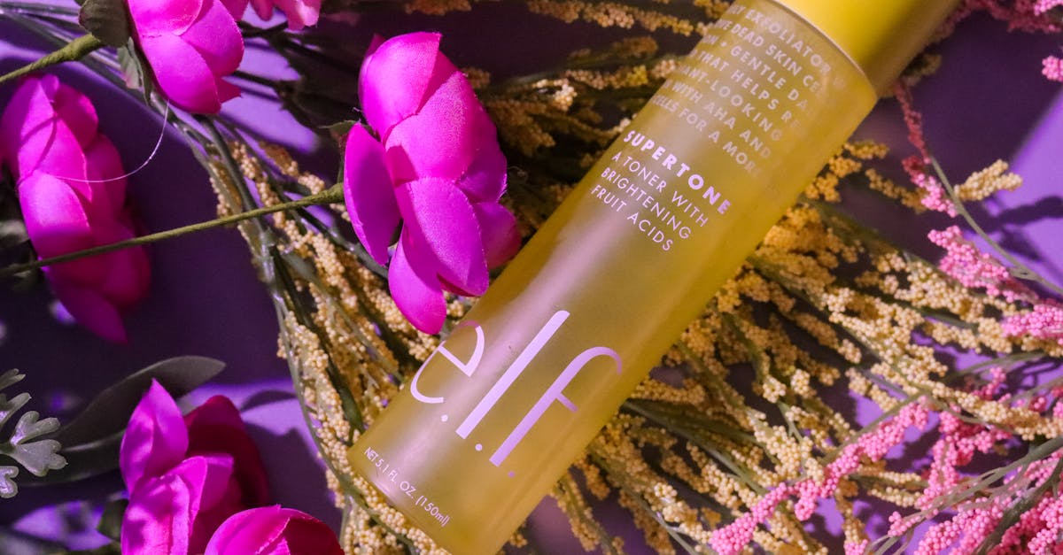 Vibrant skincare bottle with pink flowers and foliage, creating a fresh look.